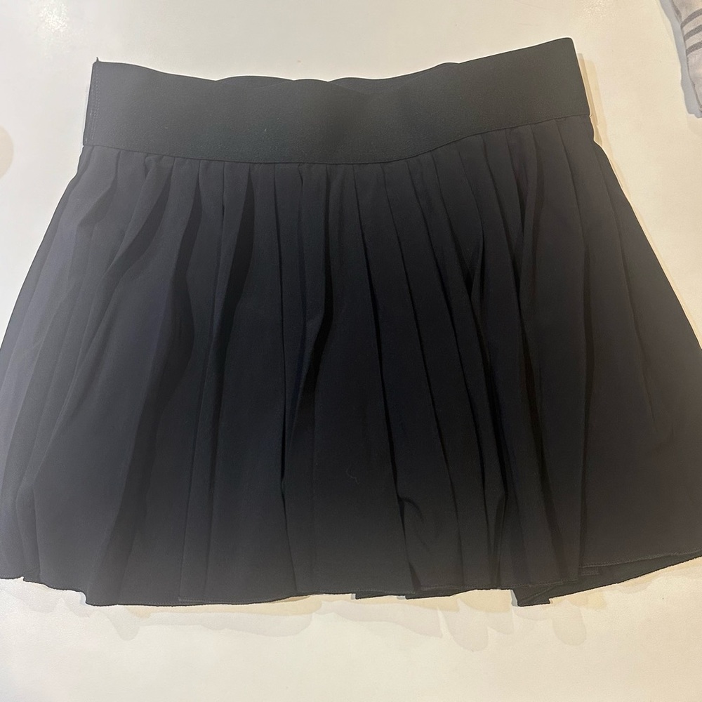 Women’s size small tennis skirt. Triaction brand and has a pocket in shorts